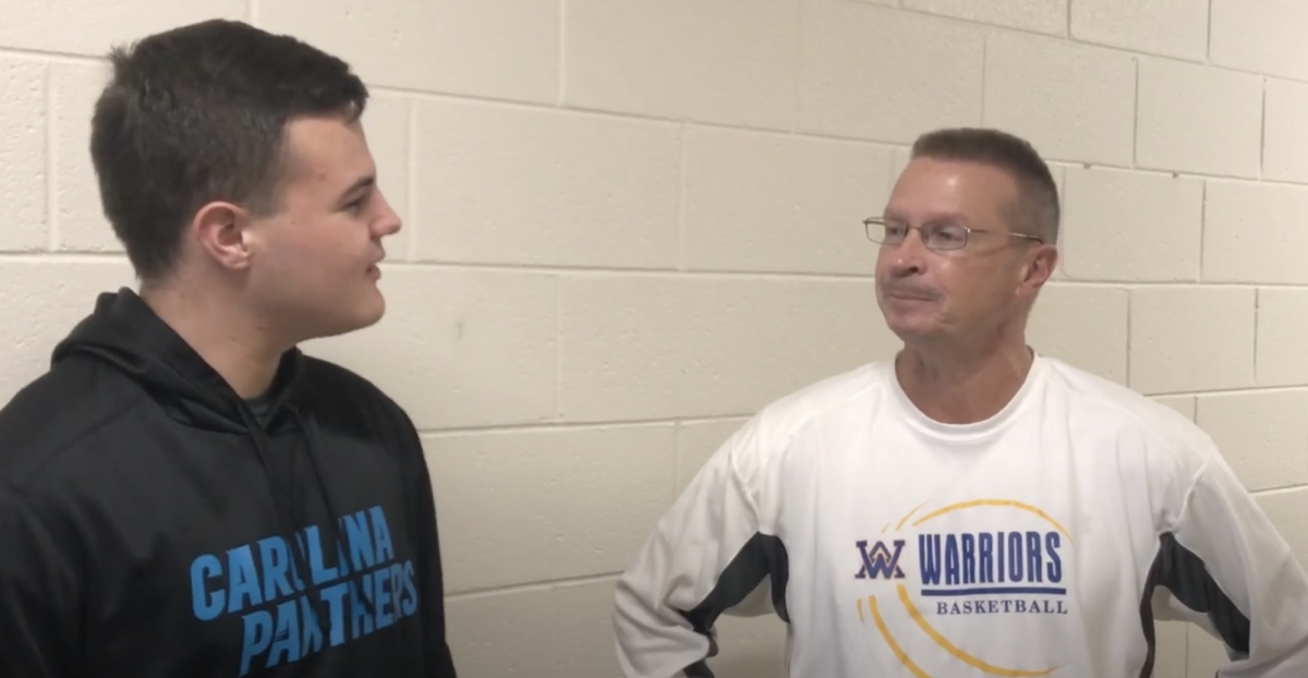 Reporter Sutton Young interviews basketball coach Darren Maynard after his 400th win in 2019. 